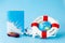 Lifebuoy, globe, model of airplane and car on blue background. Summer or vacation concept. Copy space