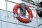 Lifebuoy on handrails of frigate or warship. Rope wound on handrails with lifesaver