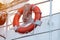 Lifebuoy on handrails of frigate or warship. Rope wound on handrails with lifesaver