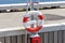 Lifebuoy hang on the pier. Concept of a safe holiday.