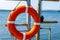 Lifebuoy hanging on the handle of the pier. The concept of saving drowning