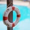 Lifebuoy hanging near swimming pool close-up