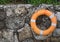 Lifebuoy hanging on a stone wall