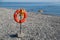 Lifebuoy hangs on the beach for the safety of people on swimming on sea