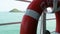 Lifebuoy and life jackets on a ferry deck close-up. Rescue equipment on a ship: buoy and vests for emergencies