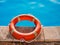 Lifebuoy lying on the background of the pool