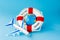 Lifebuoy, model of airplane and globe on blue background. Summer or vacation concept. Copy space