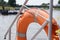 Lifebuoy orange hanging on the side of the boat, safety. boating or boating on the river for everyone