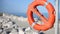 lifebuoy for people near rocks at the sea