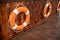 Lifebuoy Rings hanging on wooden wall panel and carpet floor.