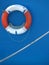 Lifebuoy and rope on blue boat