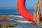 Lifebuoy and rope close-up on a background of the rocky coast