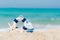 Lifebuoy on sand beach background with starfish and fishing boat, copy space.