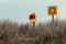 An lifebuoy on the shore, cloudy sky. Dry grass. Seaside landscape