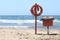 Lifebuoy to save peopleon beach on blue sea background