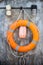 Lifebuoy on a wooden background. Help, rescue concept.