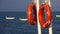 Lifebuoys hang on the pier in the sea swaying on the waves of the boat