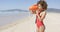 Lifeguard blowing a whistle holding rescue float