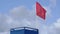 Lifeguard post with a ref flag on it informing about the danger of the wind in the sea