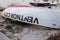 A lifeguard rescue row boat is seen upside down on the sand in storage for the winter