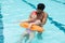 Lifeguard rescuing girl from swimming pool