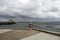 Lifeguard ring on a pipe on the shore surrounded by the sea under a cloudy sky in Fredericia