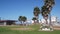 Lifeguard stand and palm tree, life guard tower for surfing on California beach.