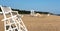 Lifeguard stands and a rescue boat on an empty beach