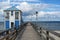 Lifeguard station house at the sea-bridge of Lubmin under a blue sky with clouds, seaside tourist resort for beach holidays at the