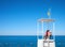 Lifeguard on tower to watching people floating