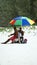 Lifeguard under a colorful umbrella