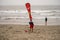 A lifeguard at Ventura Harbor posts a sign advising of hazardous currents to warn swimmers