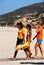 Lifeguard walking along the beach, Zahara de los Atunes, Spain.