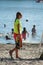 Lifeguard walking near chair in front of the lake