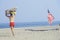 Lifeguard walking past an American flag