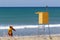 Lifeguard watching sea beach by lifeguard tower