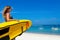 Lifeguard woman stand with surf rescue board on beach