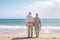 Lifelong Bonds: Elderly Couple\\\'s Beachside Walk at Sunset