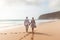 Lifelong Bonds: Elderly Couple\\\'s Beachside Walk at Sunset