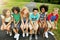 Lifes greatest treasure is friendship. a group of diverse and happy kids sitting together on a bench outside.