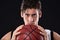 Lifes a sport, make it count. Cropped studio portrait of a determined basketball player holding the ball out in front of