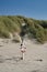 Lifesaver at station on beach with marram grass dune in background