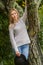 Lifestile outdoor portrait of young beautiful woman on natural b