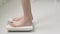 Lifestyle activity with leg of woman stand measuring weight scale for diet with barefoot, closeup foot of girl slim weight loss