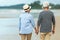 Lifestyle asian senior couple happy walking and relax on the beach.  Tourism elderly family travel leisure