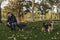 Lifestyle, attractive young couple, girl in yellow coat and boy in blue coat playing in the park with their dog