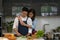 Lifestyle background of happy asian couple husband and wife having goodtime together in kitchen preparing food for launch