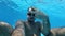 Lifestyle blogger man taking selfie video with action camera diving under water and having fun in swimming pool. Travel