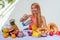 Lifestyle blonde woman blending blender juice glass jars with smoothies and straw in the summer balcony.tropical exotic