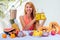 Lifestyle blonde woman blending blender juice glass jars with smoothies and straw in the summer balcony.tropical exotic